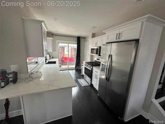 287 Fielding St, Ferndale, MI 48220 - kitchen with appliances with stainless steel finishes, white cabinets, a peninsula, dark wood-type flooring, and recessed lighting