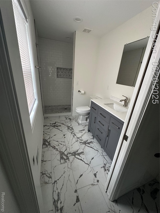 287 Fielding St, Ferndale, MI 48220 - bathroom featuring marble look tile flooring, vanity, and tiled shower