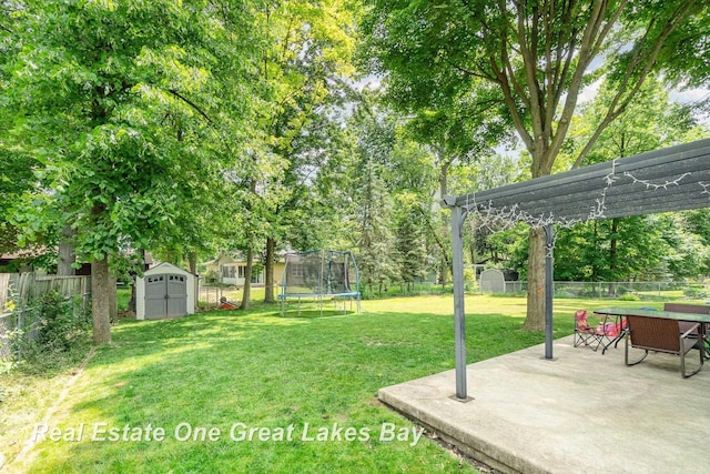 5178 Mangrove Dr, Saginaw, MI 48603 - fenced backyard featuring a storage unit, a trampoline, a patio, and a pergola