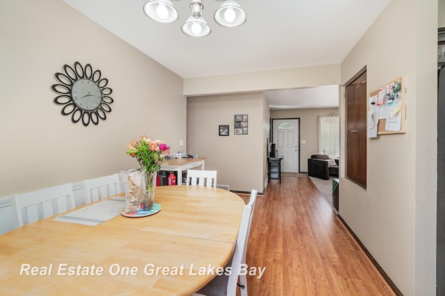5178 Mangrove Dr, Saginaw, MI 48603 - dining room featuring a chandelier and light wood-style flooring