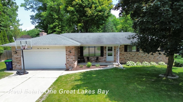 5178 Mangrove Dr, Saginaw, MI 48603 - single story home with a garage, concrete driveway, a porch, and brick siding