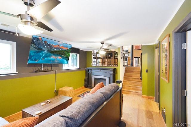 3851 Mapleleaf Rd, Waterford, MI 48328 - living area featuring a ceiling fan, a fireplace, wood finished floors, and stairway
