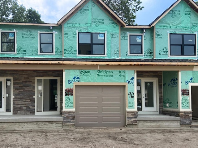 1968 S Shorewood Ln, Holland, MI 49423 - unfinished property with stone siding and a garage