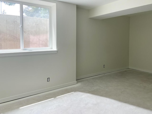 1968 S Shorewood Ln, Holland, MI 49423 - spare room with healthy amount of natural light and unfinished concrete floors