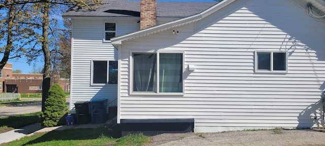 403 S Emily St, Ludington, MI 49431 - view of property exterior featuring a chimney