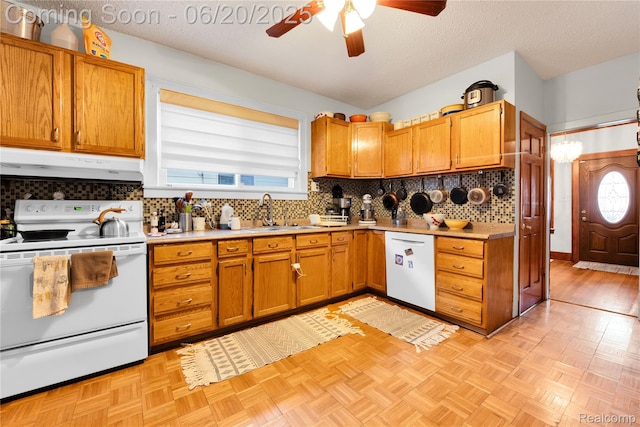 2429 Holmes St, Hamtramck, MI 48212 - kitchen featuring white appliances, range hood, a ceiling fan, decorative backsplash, and light countertops