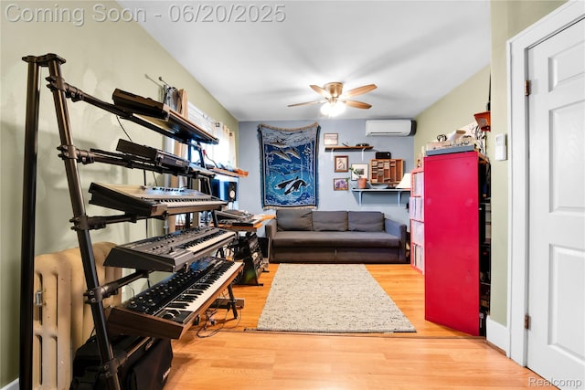 2429 Holmes St, Hamtramck, MI 48212 - living area with a wall unit AC, a ceiling fan, and wood finished floors