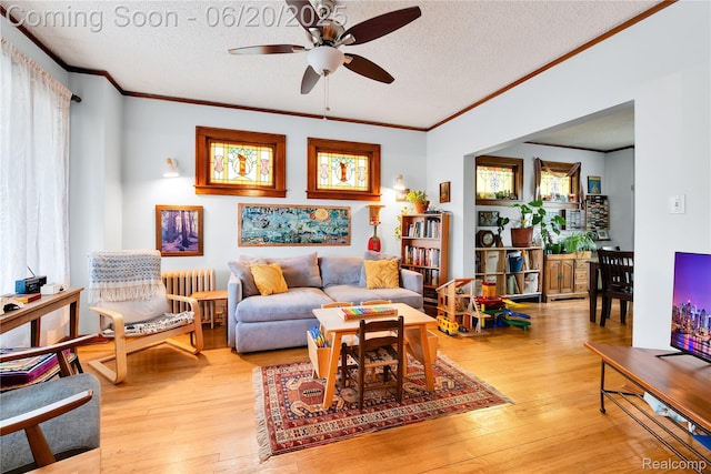 2429 Holmes St, Hamtramck, MI 48212 - living area featuring radiator, a ceiling fan, a textured ceiling, crown molding, and hardwood / wood-style flooring