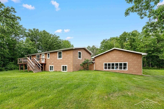 2697 W Olson Rd, Sanford, MI 48657 - rear view of property with a wooden deck, stairway, and a yard