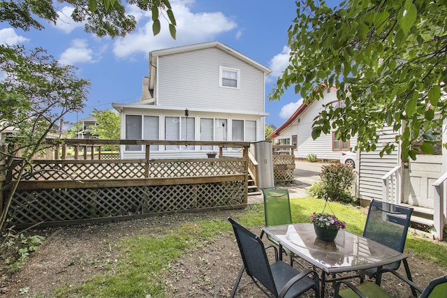 105 Clark St, Buchanan, MI 49107 - back of property with a deck, a sunroom, and outdoor dining space