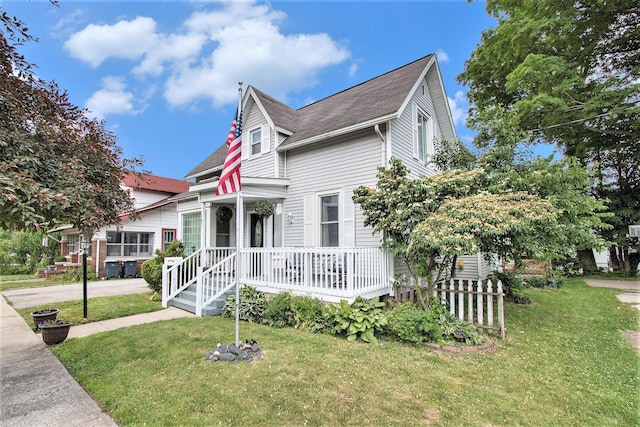 105 Clark St, Buchanan, MI 49107 - victorian home featuring a porch, a front yard, and roof with shingles