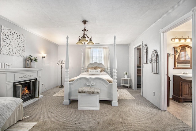 105 Clark St, Buchanan, MI 49107 - bedroom featuring ornamental molding, light carpet, a textured ceiling, a lit fireplace, and ensuite bathroom