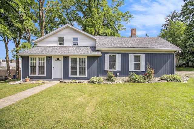 207 E Jefferson St, Cassopolis, MI 49031 - view of front facade featuring a chimney, roof with shingles, and a front yard