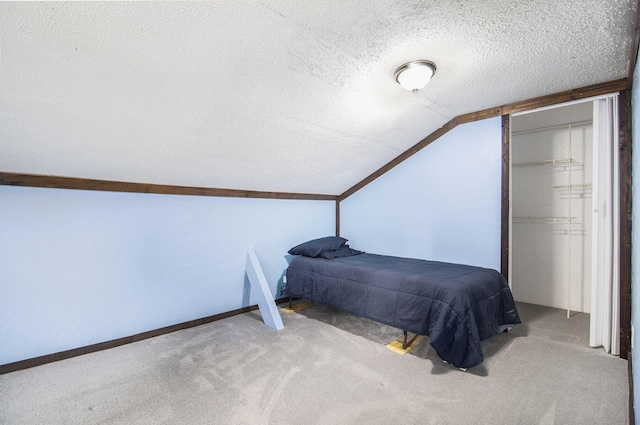 207 E Jefferson St, Cassopolis, MI 49031 - carpeted bedroom with a textured ceiling, lofted ceiling, and a closet