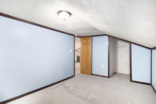 207 E Jefferson St, Cassopolis, MI 49031 - bonus room featuring a textured ceiling, light colored carpet, and lofted ceiling