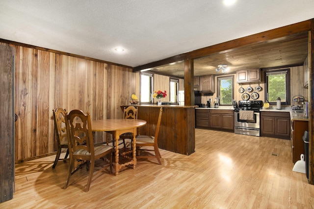 207 E Jefferson St, Cassopolis, MI 49031 - dining space featuring light wood-type flooring, wood walls, a textured ceiling, recessed lighting, and beamed ceiling