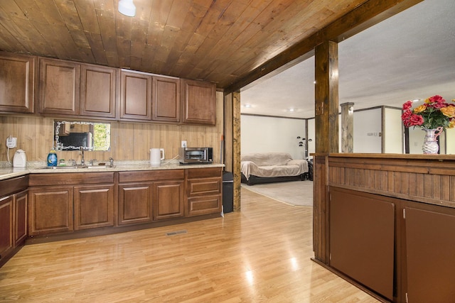 207 E Jefferson St, Cassopolis, MI 49031 - kitchen with light countertops, light wood-type flooring, and wooden ceiling