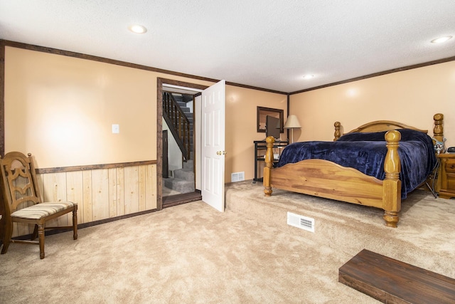 207 E Jefferson St, Cassopolis, MI 49031 - carpeted bedroom featuring ornamental molding, wainscoting, a textured ceiling, wood walls, and recessed lighting