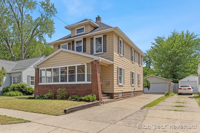 2468 Central Ave SW, Wyoming, MI 49519 - traditional style home with a detached garage, a chimney, a front lawn, an outbuilding, and brick siding