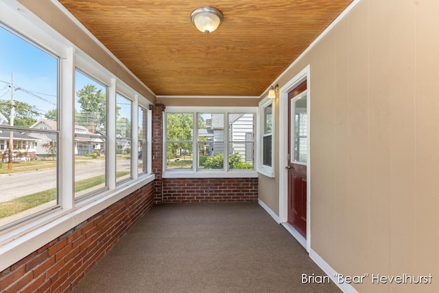 2468 Central Ave SW, Wyoming, MI 49519 - unfurnished sunroom with brick wall, wooden ceiling, carpet, and crown molding