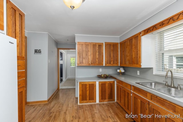 2468 Central Ave SW, Wyoming, MI 49519 - kitchen with light wood-style floors, freestanding refrigerator, brown cabinetry, ornamental molding, and light countertops