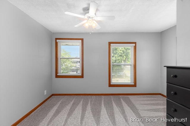 2468 Central Ave SW, Wyoming, MI 49519 - spare room with healthy amount of natural light, carpet flooring, ceiling fan, and a textured ceiling