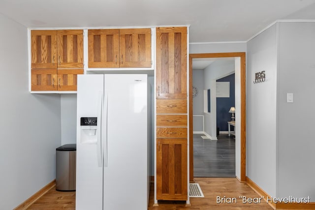 2468 Central Ave SW, Wyoming, MI 49519 - kitchen with white fridge with ice dispenser and light wood finished floors