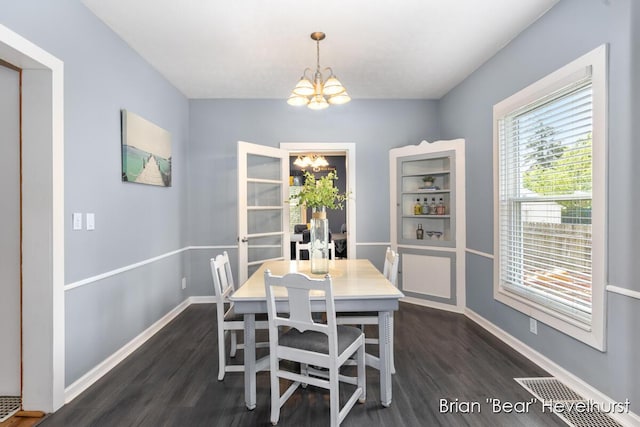 2468 Central Ave SW, Wyoming, MI 49519 - dining space featuring a chandelier and dark wood-style floors