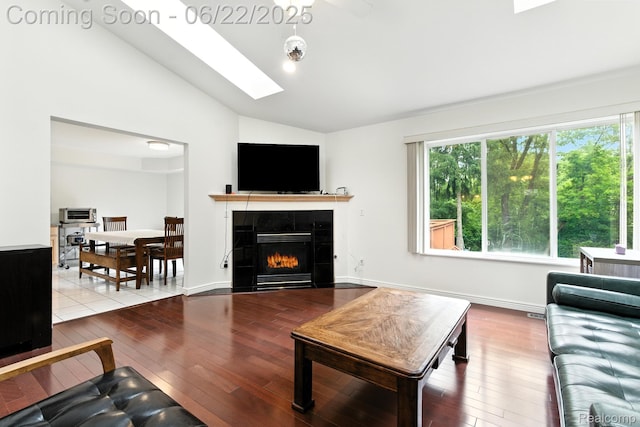 22288 Cass St, Farmington, MI 48335 - living area with lofted ceiling, hardwood / wood-style flooring, a tile fireplace, and a skylight