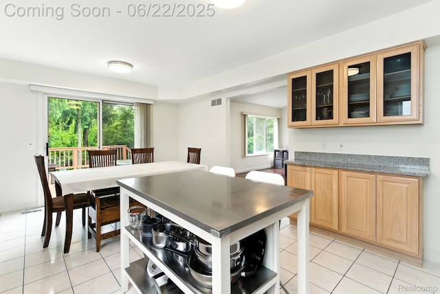 22288 Cass St, Farmington, MI 48335 - kitchen with light brown cabinets, open shelves, light tile patterned floors, and glass insert cabinets