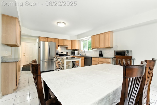 22288 Cass St, Farmington, MI 48335 - kitchen featuring stainless steel appliances, light brown cabinets, light tile patterned floors, and under cabinet range hood
