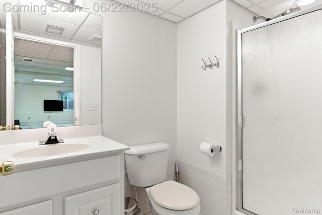 22288 Cass St, Farmington, MI 48335 - bathroom with a drop ceiling, a shower stall, vanity, and wainscoting