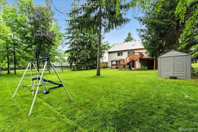 22288 Cass St, Farmington, MI 48335 - view of yard with a storage shed, a wooden deck, stairway, and a playground