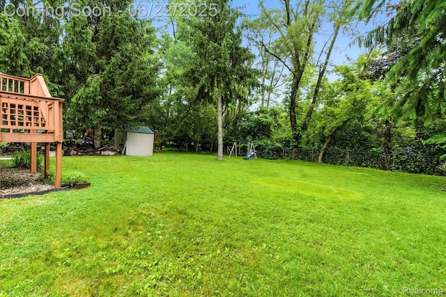 22288 Cass St, Farmington, MI 48335 - view of grassy yard with a shed, a wooden deck, and view of scattered trees