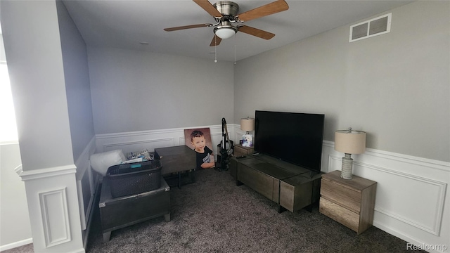 2315 Willow Ln, Grand Blanc, MI 48439 - bedroom with dark carpet, ceiling fan, and a wainscoted wall