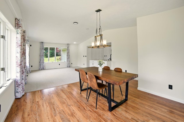 2350 155th Ave, Morley, MI 49336 - dining room featuring lofted ceiling, light wood finished floors, and a chandelier