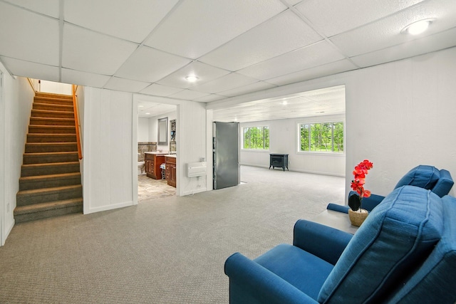 2350 155th Ave, Morley, MI 49336 - living area featuring light colored carpet, stairway, and a paneled ceiling