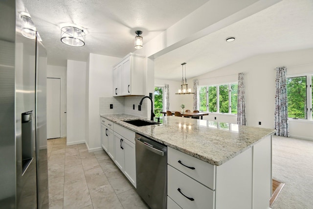 2350 155th Ave, Morley, MI 49336 - kitchen featuring appliances with stainless steel finishes, a peninsula, lofted ceiling, white cabinetry, and a chandelier