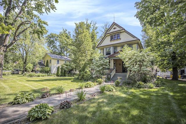 73640 Fulton St, Armada, MI 48005 - victorian home featuring a front lawn and covered porch