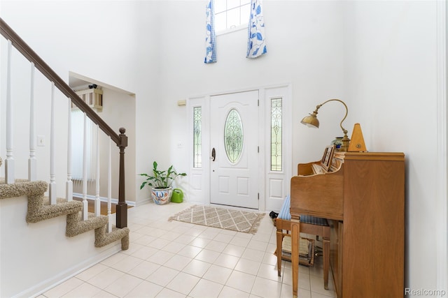 24810 Nottingham Dr, Novi, MI 48374 - foyer featuring stairway, a towering ceiling, and light tile patterned flooring