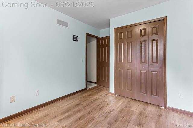 1306 Bishops Ter, Wixom, MI 48393 - unfurnished bedroom featuring light wood finished floors and a closet