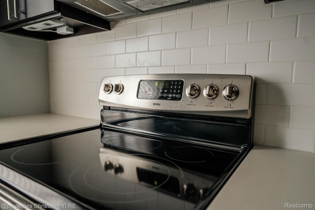 1715 E 14 Mile Rd, Birmingham, MI 48009 - kitchen view of stainless steel range with electric stovetop, tasteful backsplash, and light countertops