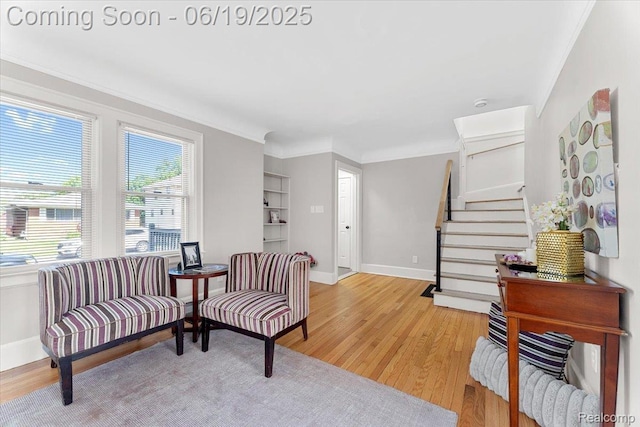 243 2nd St, Brownstown, MI 48192 - sitting room featuring stairway, light wood-style floors, and crown molding