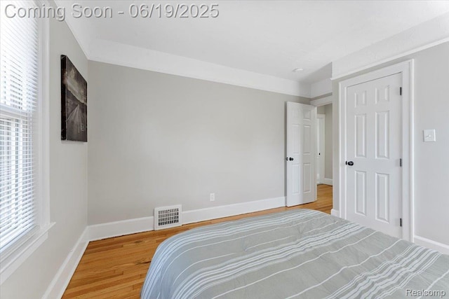 243 2nd St, Brownstown, MI 48192 - bedroom with wood finished floors and multiple windows