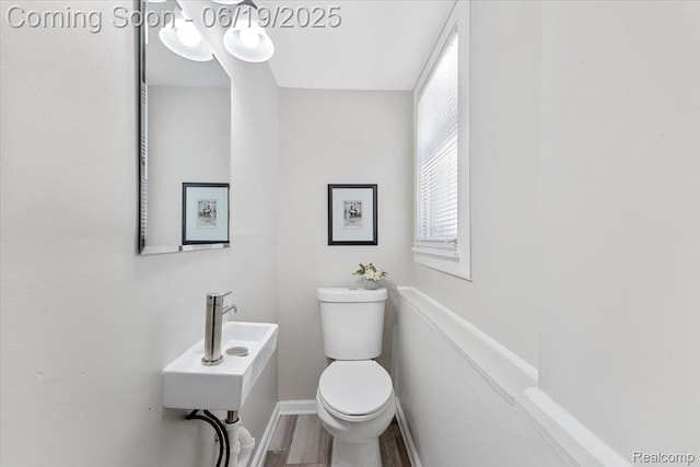 243 2nd St, Brownstown, MI 48192 - bathroom with toilet and wood finished floors