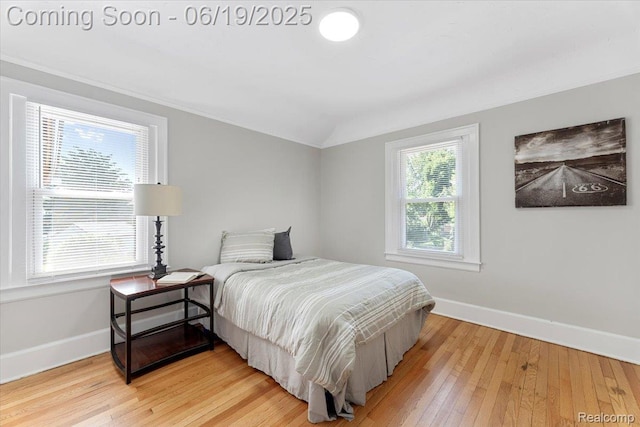 243 2nd St, Brownstown, MI 48192 - bedroom with light wood-style flooring, vaulted ceiling, and crown molding