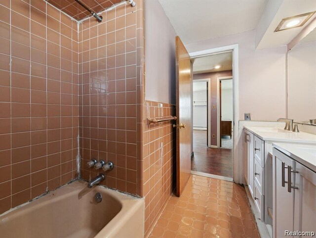 664 Buckingham Ave, Lincoln Park, MI 48146 - full bath with double vanity, shower / bathtub combination, and wainscoting