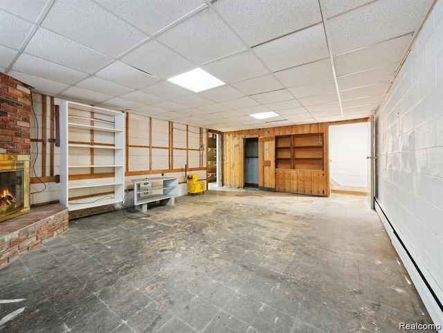 664 Buckingham Ave, Lincoln Park, MI 48146 - unfurnished living room featuring a baseboard heating unit, a paneled ceiling, and a fireplace