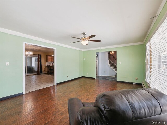 664 Buckingham Ave, Lincoln Park, MI 48146 - living room with stairs, wood-type flooring, crown molding, a chandelier, and ceiling fan