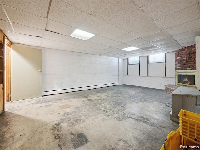 664 Buckingham Ave, Lincoln Park, MI 48146 - below grade area featuring a baseboard heating unit, a paneled ceiling, and concrete block wall